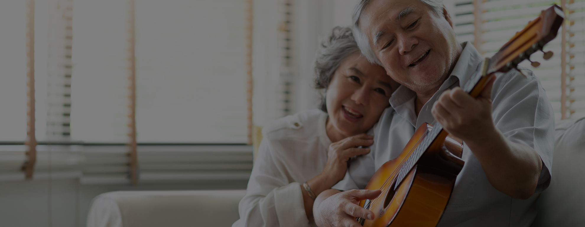 Man playing guitar with wife