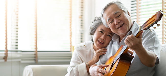Man playing guitar for his wife