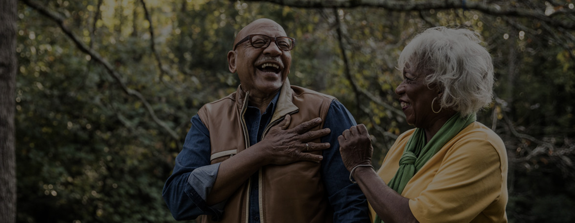 Man and woman walking through forest. 