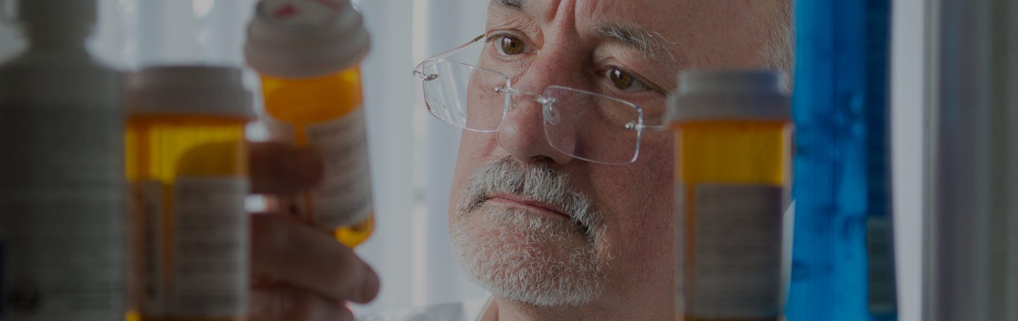 Man looking at pills.