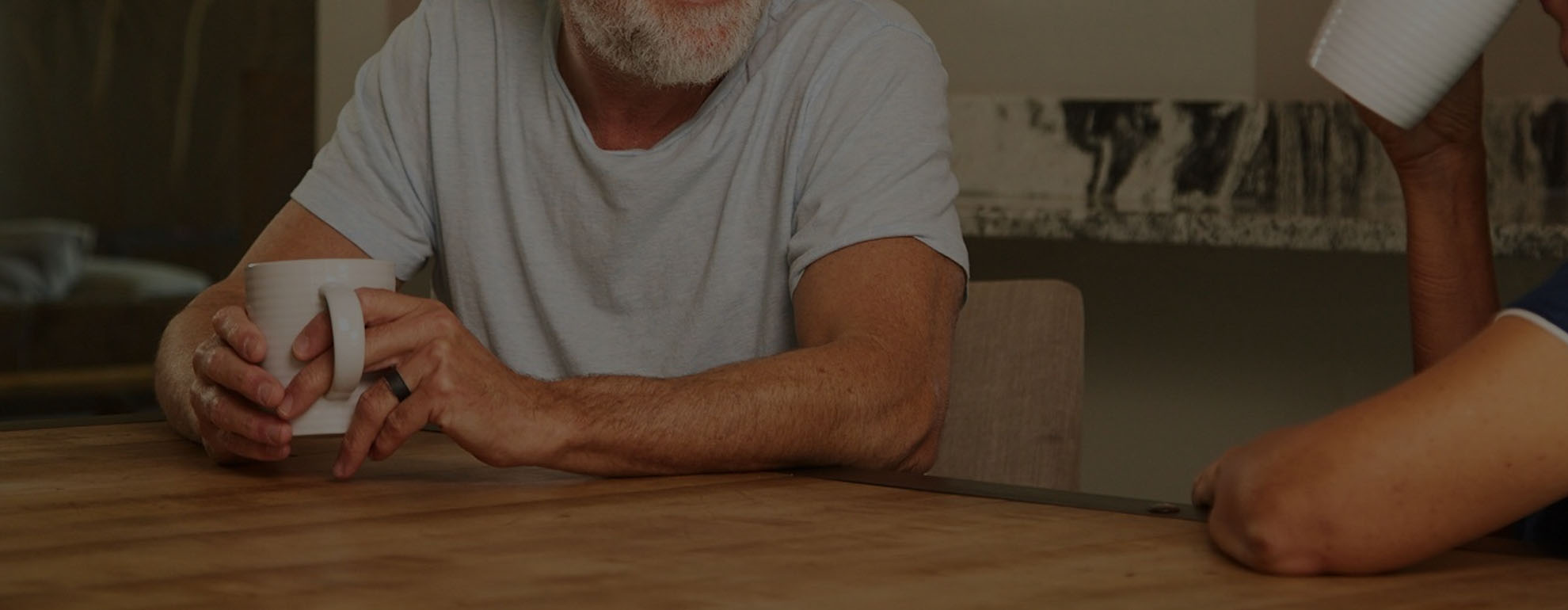 Man drinking coffee with wife